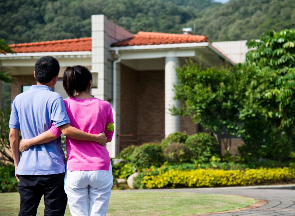 Couple embracing as they stare at home